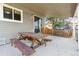 Covered patio with wooden picnic table for outdoor gatherings at 9375 W David Ave, Littleton, CO 80128