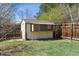 Backyard shed and fenced yard with mature trees at 9375 W David Ave, Littleton, CO 80128