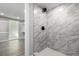 Bathroom with marble-look tiling in shower with hexagon tile base at 832 Dahlia St, Denver, CO 80220