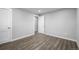 Spacious bedroom featuring wood-look flooring and fresh white trim at 832 Dahlia St, Denver, CO 80220