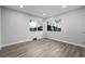 Bedroom with windows, neutral walls, wood-look flooring, and fresh white trim at 832 Dahlia St, Denver, CO 80220