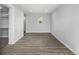 Bright and open bedroom featuring gray wood-look flooring and fresh white trim at 832 Dahlia St, Denver, CO 80220