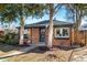 Cozy brick house with mature trees, offering shade and curb appeal at 832 Dahlia St, Denver, CO 80220