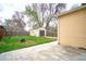 Backyard view with detached garage, lawn area, and mature landscaping at 504 Martin St, Longmont, CO 80501