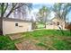 Landscaped backyard featuring garden beds and a detached garage at 504 Martin St, Longmont, CO 80501