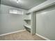 Basement bedroom with neutral colored carpet, closet with shelving, and a small window at 504 Martin St, Longmont, CO 80501