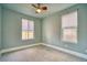 Bedroom featuring neutral carpet, two windows, and neutral paint at 504 Martin St, Longmont, CO 80501