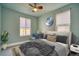 Bedroom featuring a ceiling fan, two windows, and decoratively designed with a moon at 504 Martin St, Longmont, CO 80501