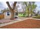Street view of the home highlighting the manicured front yard, mature trees, and neighborhood charm at 504 Martin St, Longmont, CO 80501