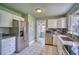 Well-equipped kitchen with stainless steel appliances, granite counters, white cabinets, and tile flooring at 504 Martin St, Longmont, CO 80501