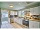Modern kitchen with white cabinets, stainless steel appliances, granite countertops, and a stylish backsplash at 504 Martin St, Longmont, CO 80501