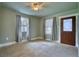 Cozy living room showcasing carpet flooring, large windows with curtains, and a decorative front door at 504 Martin St, Longmont, CO 80501