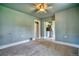 Bright and airy living room with a ceiling fan and carpeted floors, seamlessly connecting to the kitchen area at 504 Martin St, Longmont, CO 80501