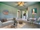 Charming living room featuring a decorative ceiling fan, stylish furnishings, and an adjoining kitchen area at 504 Martin St, Longmont, CO 80501