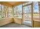 Inviting enclosed front porch featuring large windows providing ample natural light and neighborhood views at 504 Martin St, Longmont, CO 80501