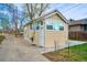 Rear exterior showing a sunroom addition with large windows and a white exterior door at 504 Martin St, Longmont, CO 80501