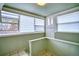 The sunroom features tile flooring, many windows, and a door to the exterior at 504 Martin St, Longmont, CO 80501