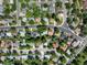 Overhead view of a peaceful residential area with tree-lined streets and a mix of colorful rooftops at 9656 Rensselaer Dr, Arvada, CO 80004