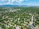 Expansive aerial perspective of a suburban community, lush landscapes, and distant mountain views at 9656 Rensselaer Dr, Arvada, CO 80004