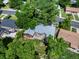 Aerial view of property showcasing landscaped backyard, patio, and mature trees for privacy at 9656 Rensselaer Dr, Arvada, CO 80004