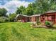 Scenic backyard view showcases lush lawn, a gazebo, and mature trees at 9656 Rensselaer Dr, Arvada, CO 80004