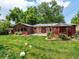 Relaxing backyard featuring a manicured lawn, mature trees, and gazebo at 9656 Rensselaer Dr, Arvada, CO 80004