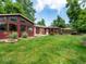 Expansive backyard featuring lush lawn, a charming gazebo, and an attached sunroom for versatile outdoor enjoyment at 9656 Rensselaer Dr, Arvada, CO 80004