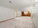 Spacious basement with plush carpet and built-in shelving at 9656 Rensselaer Dr, Arvada, CO 80004