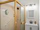 Bathroom with glass shower, modern vanity, and natural light at 9656 Rensselaer Dr, Arvada, CO 80004