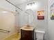 Classic bathroom with a yellow tub, pedestal sink, and decorative artwork at 9656 Rensselaer Dr, Arvada, CO 80004