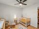 Bright Bedroom with wooden floors, white crib, and a mobile at 9656 Rensselaer Dr, Arvada, CO 80004