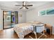 Serene bedroom features a sliding glass door to porch, and hardwood floors at 9656 Rensselaer Dr, Arvada, CO 80004