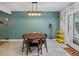 Cozy dining area adjacent to the kitchen, featuring a stylish light fixture and ample seating at 9656 Rensselaer Dr, Arvada, CO 80004