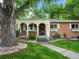 Charming single-story home with brick and stucco exterior, mature tree, and manicured lawn at 9656 Rensselaer Dr, Arvada, CO 80004