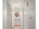 Hallway decorated with picture art and wood floors at 9656 Rensselaer Dr, Arvada, CO 80004