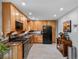 Bright and spacious kitchen with wooden cabinets, granite countertops, and modern appliances at 9656 Rensselaer Dr, Arvada, CO 80004