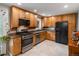 Well-lit kitchen featuring wooden cabinets, granite countertops, and stainless steel appliances at 9656 Rensselaer Dr, Arvada, CO 80004