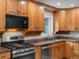 Traditional-style kitchen with granite countertops, stainless steel appliances, and wooden cabinets at 9656 Rensselaer Dr, Arvada, CO 80004