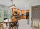 Bright kitchen with stainless steel appliances, wooden cabinets, and tile flooring with a view to the basement at 9656 Rensselaer Dr, Arvada, CO 80004