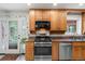 Functional kitchen space featuring stainless steel appliances and ample cabinet storage at 9656 Rensselaer Dr, Arvada, CO 80004