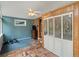 Laundry room featuring bi-fold closet, carpet and tile flooring, and teal accent wall at 9656 Rensselaer Dr, Arvada, CO 80004