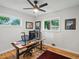 Home office featuring a modern desk setup and two windows overlooking the yard at 9656 Rensselaer Dr, Arvada, CO 80004