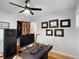 Well-lit home office with framed diplomas, closet, and modern computer setup at 9656 Rensselaer Dr, Arvada, CO 80004