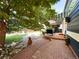 Beautiful backyard with brick patio, mature trees, and lush landscaping at 4049 S Quatar St, Aurora, CO 80018