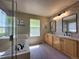 Bright primary bathroom with a double sink vanity, a tub, and a separate glass shower enclosure at 4049 S Quatar St, Aurora, CO 80018