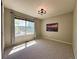 Bedroom with a large window, modern light fixture and neutral carpet at 4049 S Quatar St, Aurora, CO 80018