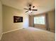 Spacious carpeted bedroom with a ceiling fan and large window at 4049 S Quatar St, Aurora, CO 80018
