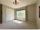 Bedroom with a large window, modern light fixture and closet with sliding doors at 4049 S Quatar St, Aurora, CO 80018