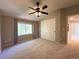 Carpeted bedroom with a ceiling fan, window, and closet with sliding doors at 4049 S Quatar St, Aurora, CO 80018