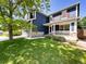 Charming two-story home with blue siding, red shutters, a stone foundation and a well-manicured lawn at 4049 S Quatar St, Aurora, CO 80018